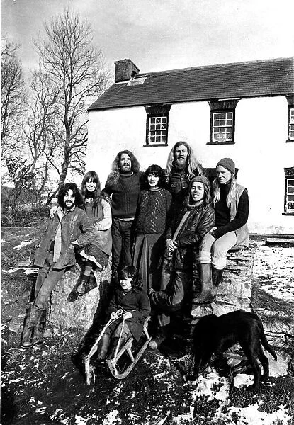 Communes - Eight members of the commune pose in the sunshine outside their farmhouse at