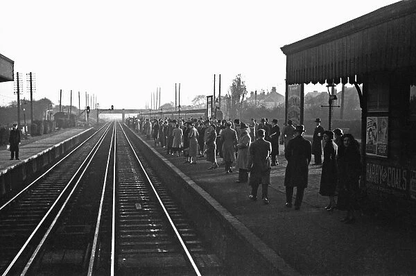 Commuters await the next train to Waterloo. November 1938
