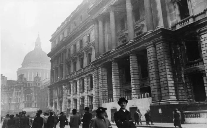 Framed Print : Commuters pass the burnt out shell of the Central Telegraph Office on the corner of Framed Print : Commuters pass the burnt out shell of the Central Telegraph Office on the corner of