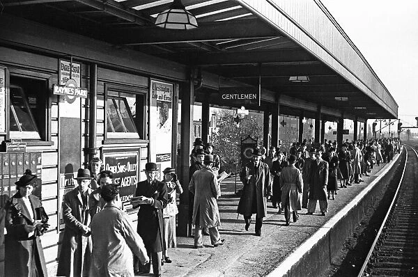 Commuters at Rayners Park await the next train to Waterloo. November 1938