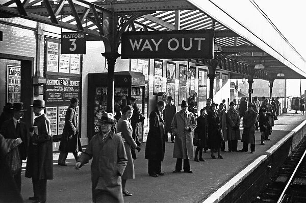 Commuters and schoolchildren on platform three of Kingston Station await the next train