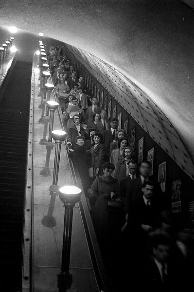 Commuters seen here taking the escalator down to the Central Line during the rush hour at