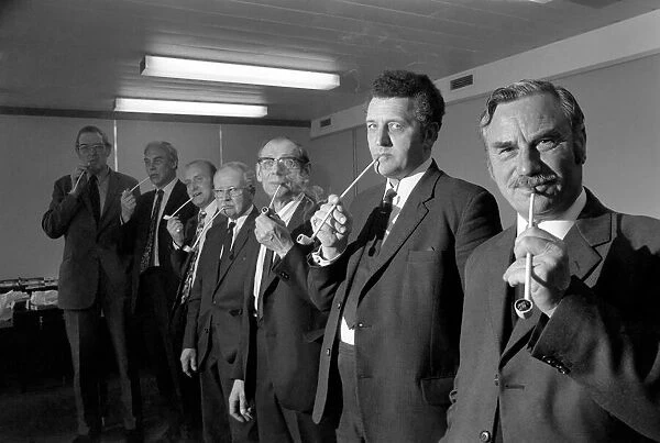 Competitiors in the British National Pipe Smoking Championship puffing on their pipes