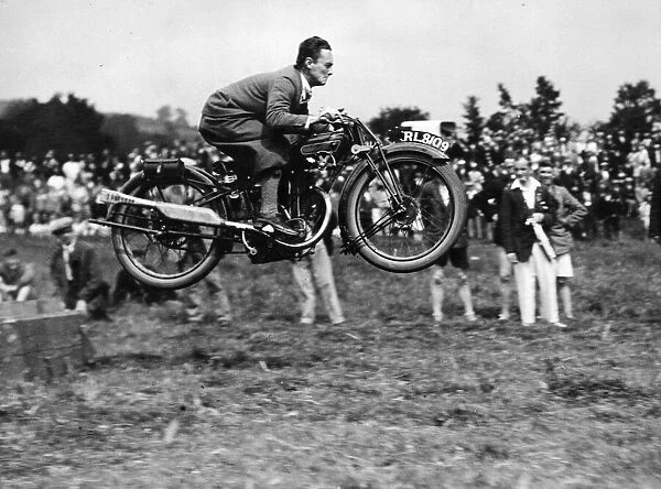 A competitor doing a long jump on his motor-cycle during the sports held in connection
