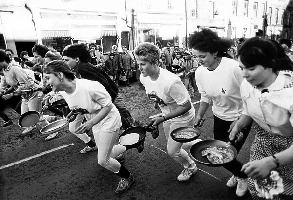 Competitors take part in the Alnwick Shrove Tuesday Pancake race 16 February 1988
