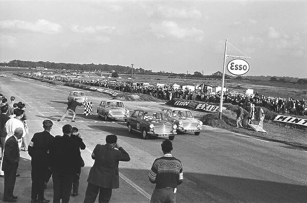 Competitors take the checkered flag in the Molyslip Morris 1100 race at Snetterton race