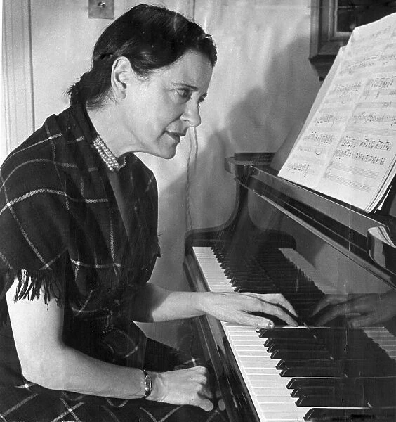 Concert pianist Harriet Cohen, practiicng the piano left handed after she injured her