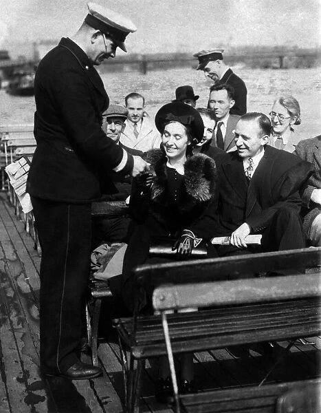 Conductor taking fares on The Thames river bus service at the begining of the blitz