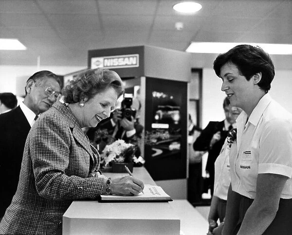 Conservative Prime Minister Margaret Thatcher, signs the visitors book at the Nissan