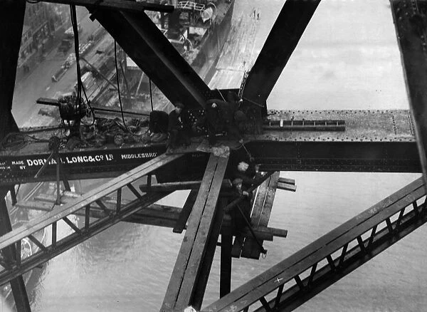 Construction of the new Tyne Bridge. Riveters at work on the lower boom