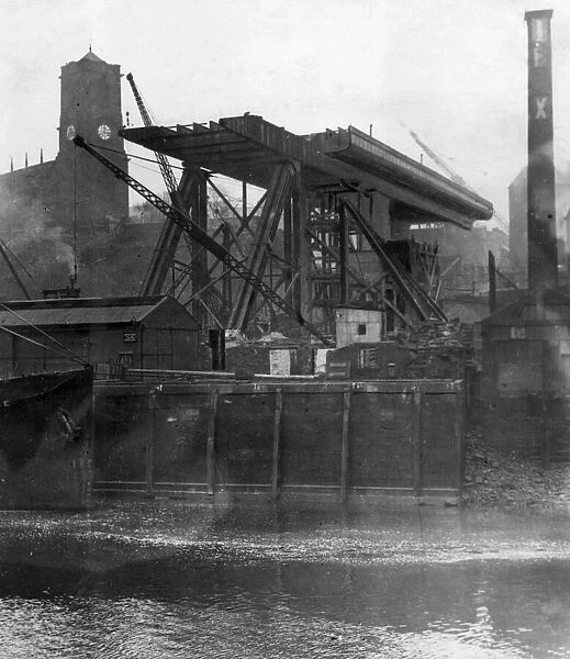 Construction of the Tyne Bridge. A view from the river showing progress being made with