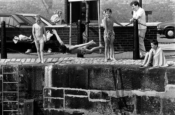 Cooling off with a dive into the water around Albert Dock, Liverpool, Merseyside