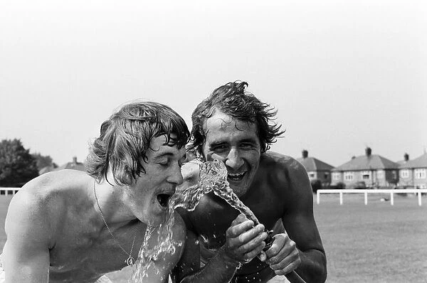 Cooling off after training in a heatwave are Leicester City footballers Steve Kember