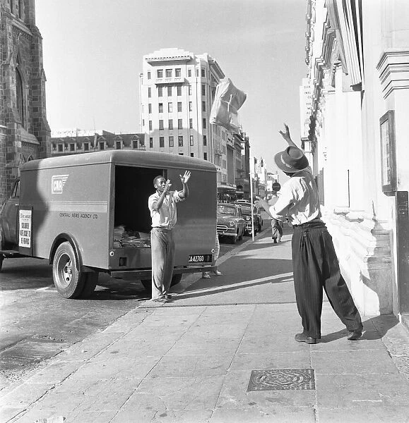 Copies of The Cape Argus are tossed to waiting delivery van in Capetown 4th February 1955