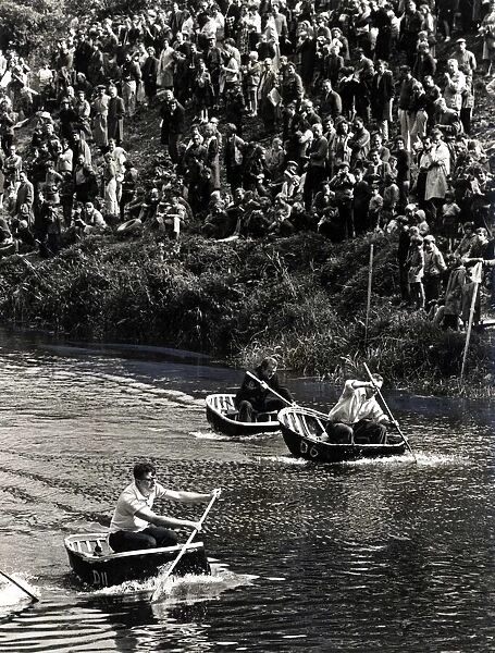 Coracle Racing - Tense moment during a coracle race as crowds line the banks of the River
