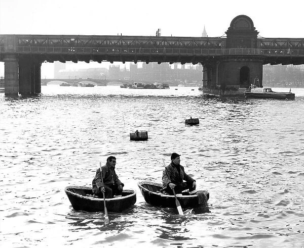 Coracles being paddled for the first time on the River Thames