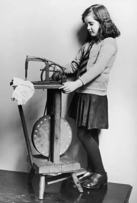 Framed Print : Corinne Griffith seen here in the role of Mary Boyne sitting working at a Singer sewing
