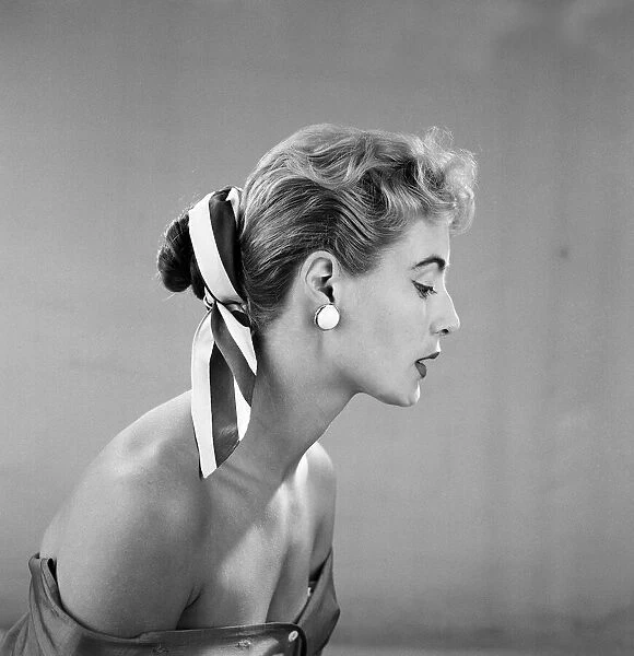 Cotton scarf and flower decorations for the hair, modelled by Pat O Reilly. July 1955