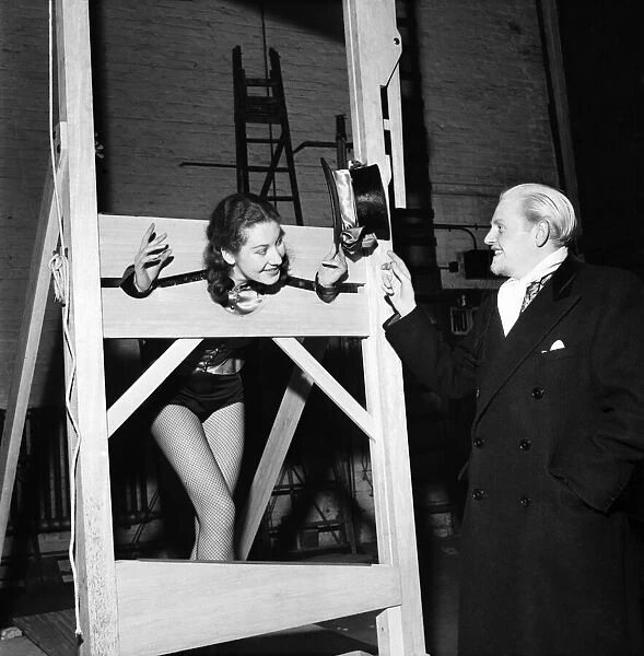 Count Dominic tries out his guillotine on Marion Dorie while Penny Kay
