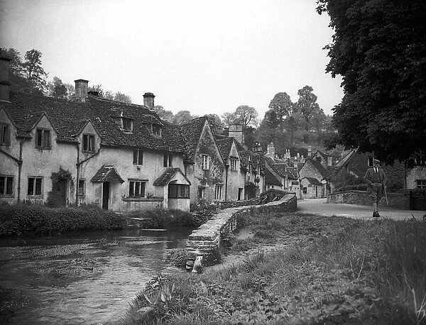 A country scene, Castle Combe in Wiltshire, 1943 A man strolls through a country