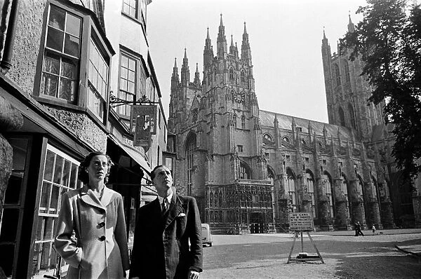 A couple in Canterbury during Canterbury Week, Kent. Canterbury Cathedral in