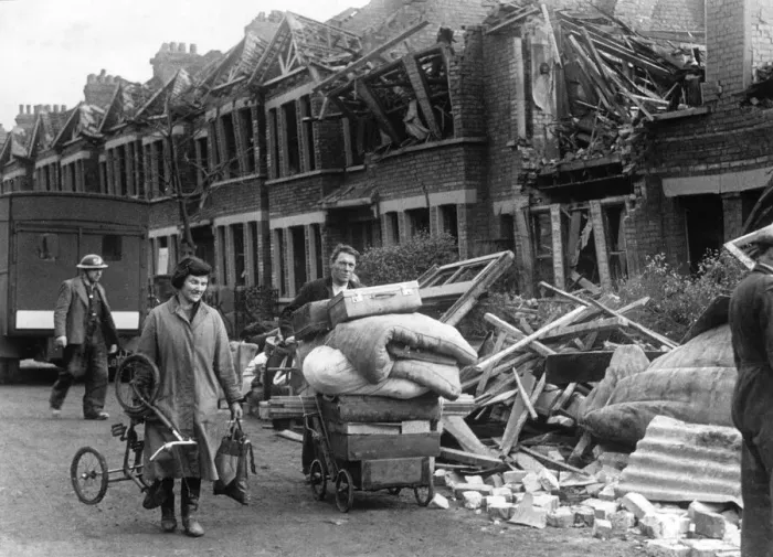 Framed Print : Couple carrying the remaining possessions from their bombed home in a pram following an Framed Print : Couple carrying the remaining possessions from their bombed home in a pram following an