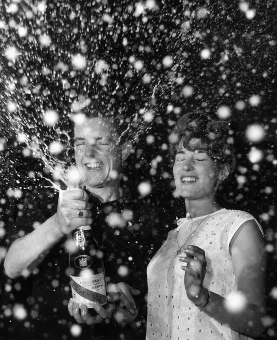 Framed Print : Couple celebrate the new year with a bottle of champagne 1st January 1965