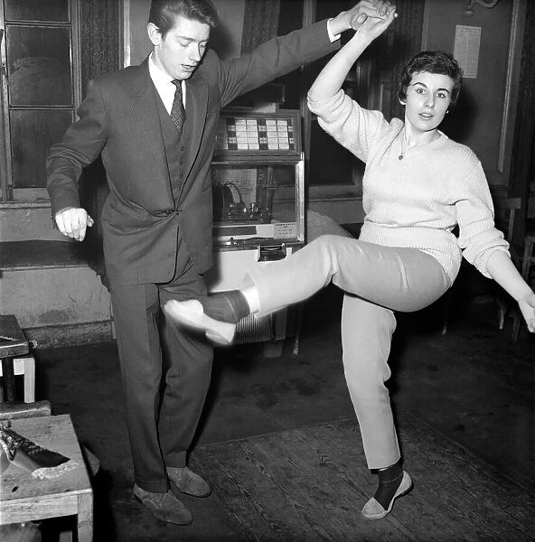 Couple dancing to music from juke box. 1960