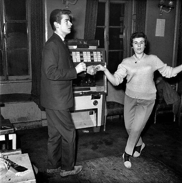 Couple dancing to music from juke box. 1960