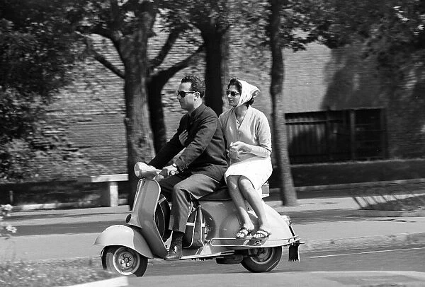 Couple Drive around on a Moped in Rome, Italy