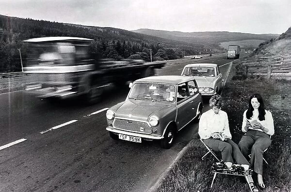 Couple enjoy a picnic on the A74 in Scotland. Roadside