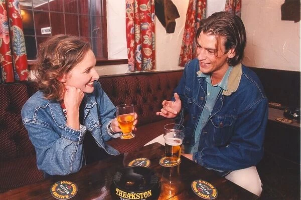 A couple enjoying a night out in a bar pub