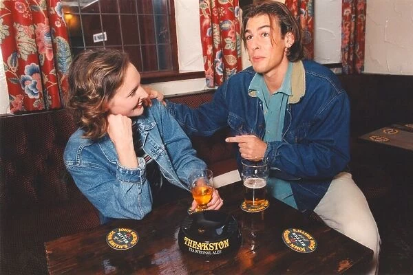 A couple enjoying a night out in a bar pub