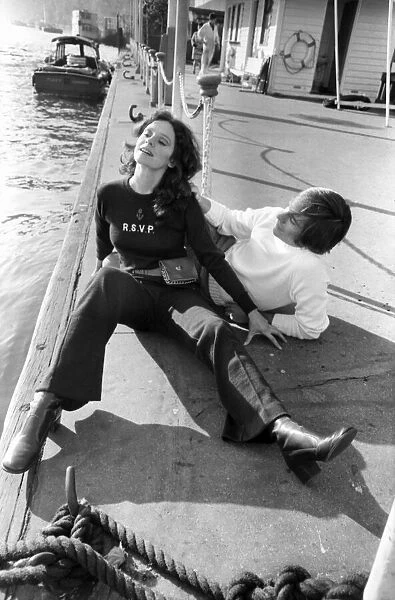 Couple wearing the latest leisurewear pose by a boat. November 1969 Z10672-002