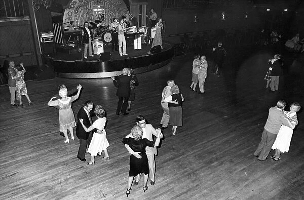 Couples enjoying a spin round the floor ballroom dancing