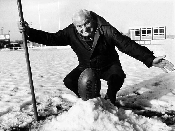 Coventry rugby union match secretary Harry Walker places the ball on a snow mound at