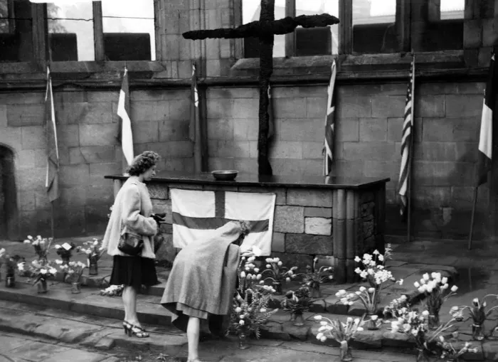 Framed Print : Two Coventry women place flowers in the sanctuary in the cathedral ruins in rememberance