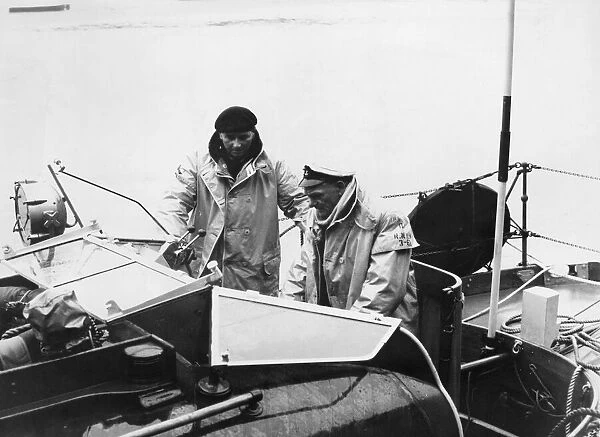 The Coxswain, Mr Fred Swarts, in the cockpit, and Mr John Wells, the signaller