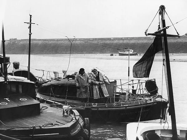 The coxswain, Mr Fred Warts and the signalman Mr John Wells tie up the Barry lifeboat