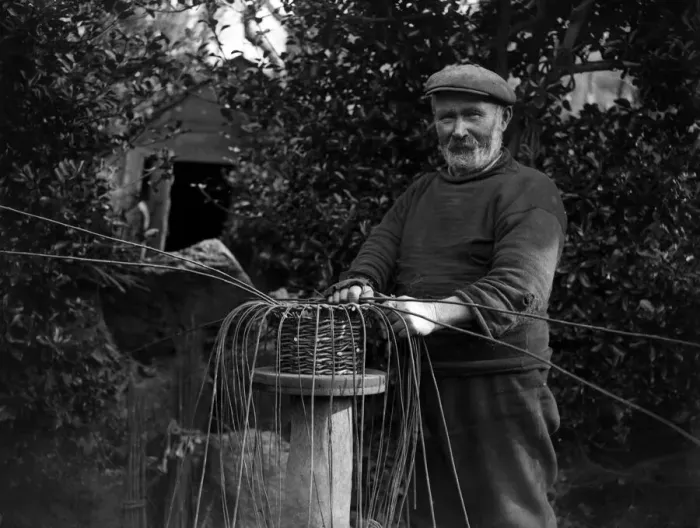 Framed Print : The crab pot industry at Penberth, Cornwall. Bending the willows into shape