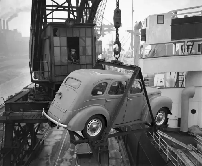 Framed Print : A crane operator seen here lifting one of the Ford Prefects