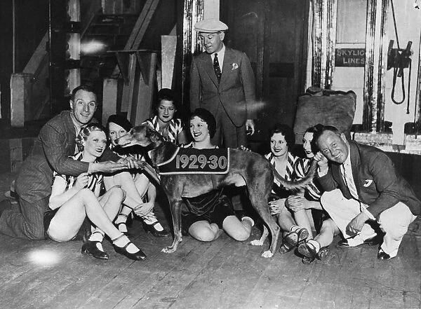The Crazy Gang members with showgirls from the London Palladium with greyhound Mick