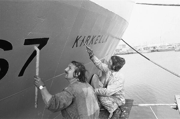 The crew of the Hull based stern trawler Kirkella seen here repainting the ships name