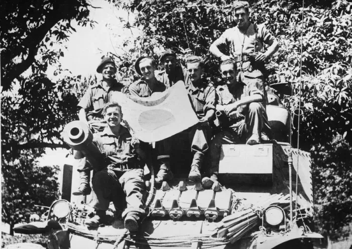 Framed Print : The crew of a Lee tank pose with a captured Japanese flag during the advance south of Framed Print : The crew of a Lee tank pose with a captured Japanese flag during the advance south of