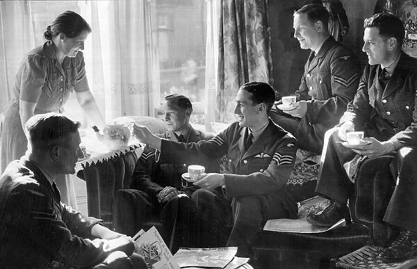 Crew and officers of the RAF enjoying a cup of tea from their host in Blackpool during