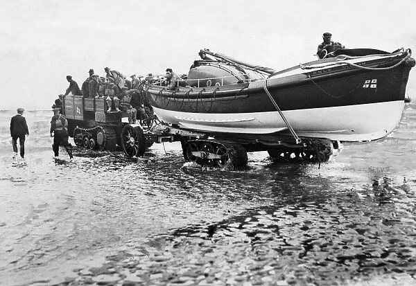 The crew of the RNLB Oldham wheel the lifeboat down the beach at Hoylake Lifeboat Station