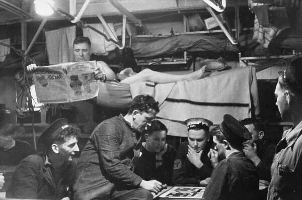 The crew of a Royal Navy escort destroyer enjoying a rest period below decks between