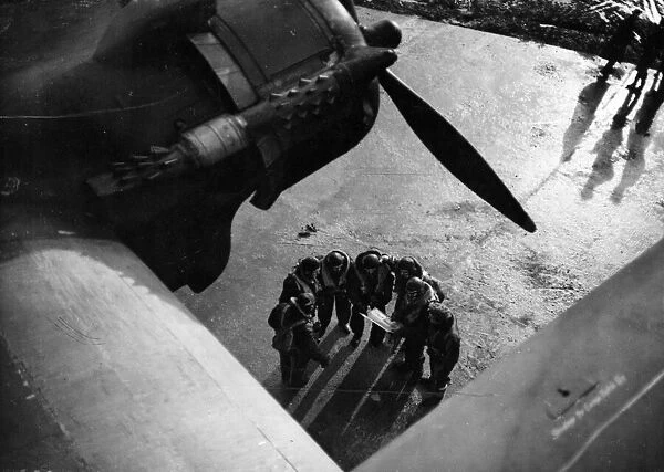 The crew of a Stirling bomber consulting a map. February 1942