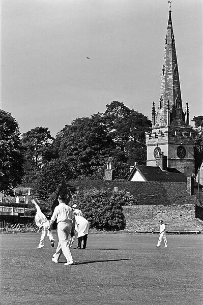 A cricket match takes place in the village of Wombourne in Staffordshire, England