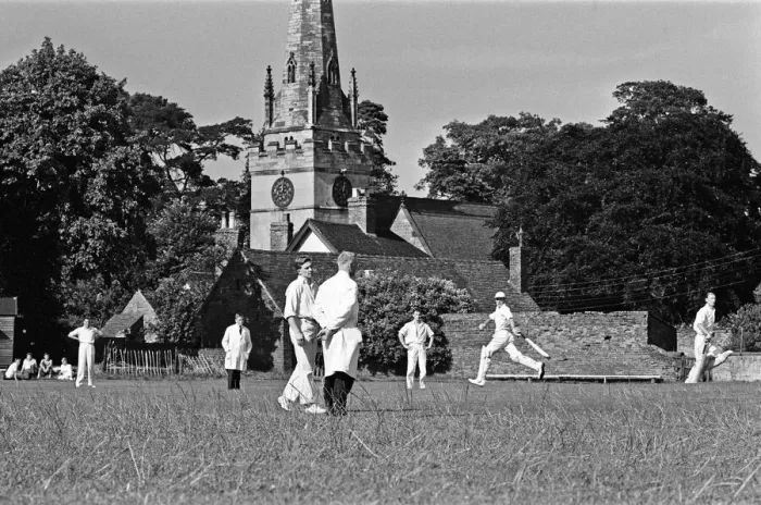 Framed Print : A cricket match takes place in the village of Wombourne in Staffordshire, England Framed Print : A cricket match takes place in the village of Wombourne in Staffordshire, England